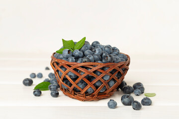 Bowl with fresh bright blueberries on wooden table