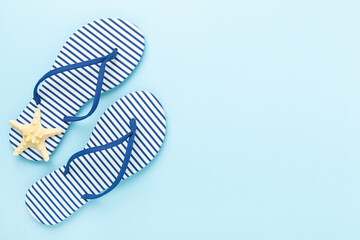 Striped blue flip flops on color background, top view