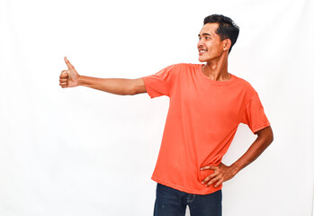 Naklejka premium Young Person Wearing Orange Top Gesturing Approval Against Plain Background