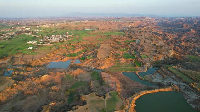 Aerial view of village between hills in Chakwal, Pakistan.