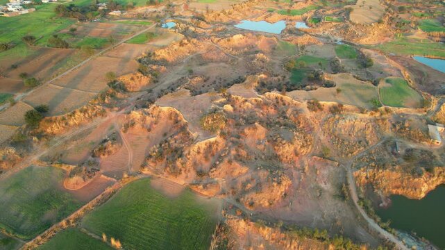 Aerial view of village between hills in Chakwal, Pakistan.