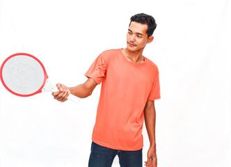 Young Man In Orange Shirt Holding Electronic Fly Swatter