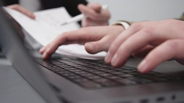Two businessmen brainstorming with charts, papers, and a computer. Concept effective teamwork, strategy planning, and small business startup growth in an office environment.