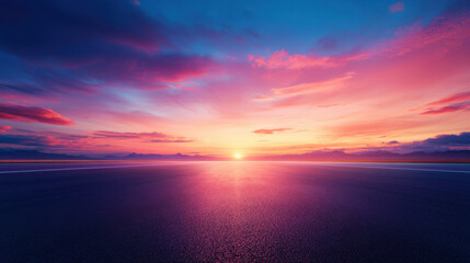 Fototapeta premium Breathtaking sunset over smooth road, showcasing vibrant colors and serene atmosphere. horizon blends hues of pink, orange, and purple, creating tranquil scene