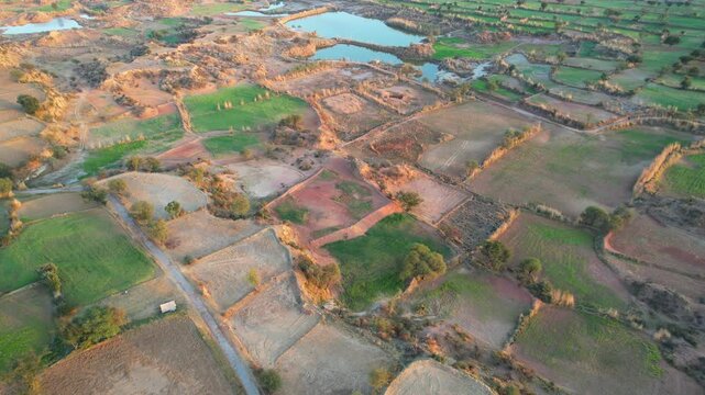 Aerial view of village between hills in Chakwal, Pakistan.