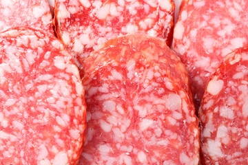 Pieces of tasty smoked sausage as background, closeup