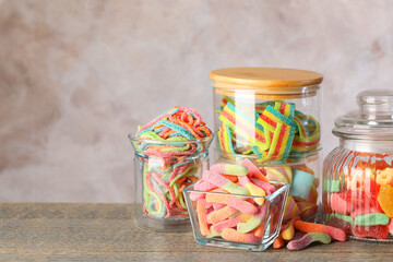Candy bar. Many different sweets on wooden table against grey background. Space for text