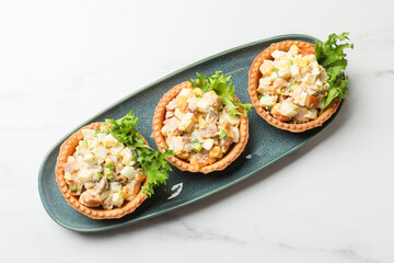 Tartlets with delicious filling on white marble table, top view