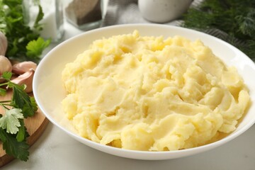 Delicious mashed potato served on white table, closeup