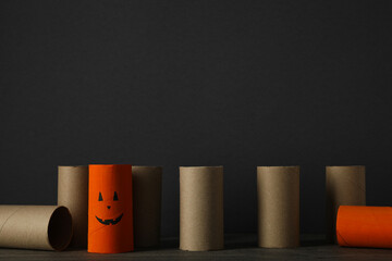 Paper rolls on wooden table on gray background, space for text