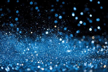Blue particles glitter against a black backdrop, creating celebration.