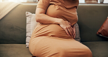 Home, pregnant woman and hands on stomach for ache, discomfort or baby growth with development....