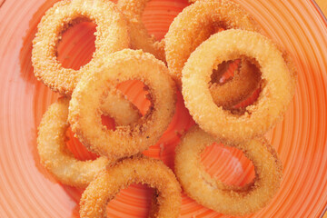 Crispy onion rings served in a vibrant bowl on a table