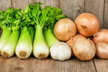 Fresh Celery Stalks and Onions on Rustic Wooden Table for Healthy Cooking Inspiration