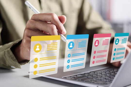 Concept of online recruitment, job applications, and human resources. HR manager use laptop to checking cv resume on virtual screen for team building.