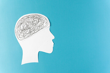 A white head silhouette filled with scribbles, placed against a clear, vibrant blue background.