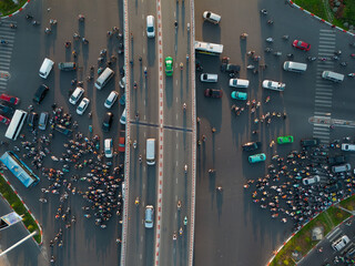 Aerial Top View of a Bustling Intersection in Ho Chi Minh City at Sunset with Chaotic Traffic -...