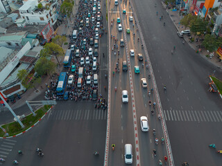 Angle Aerial View of Chaotic Traffic at a Bustling Intersection in Ho Chi Minh City at Sunset 