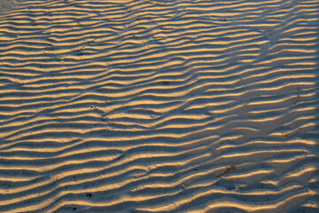 Soft light on ripples on beach sand image in horizontal format for background use