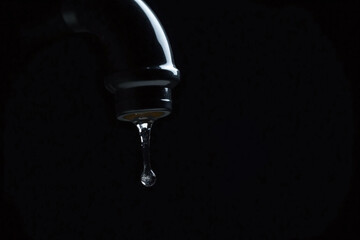 faucet with a drop of water coming out of it