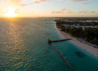 A beautiful blue ocean with a sunset in the background
