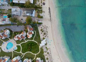 A beach with a resort and a pool