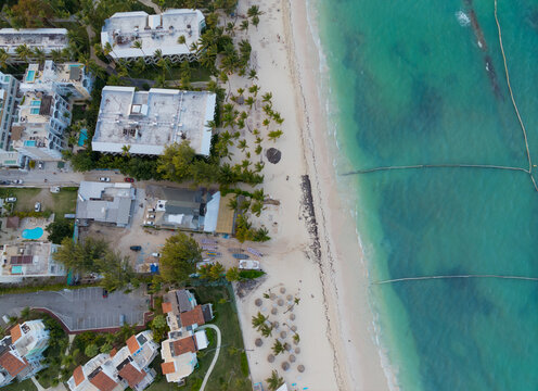 A beach with a few buildings in the background
