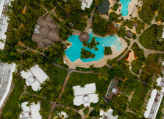 A beautiful tropical resort with a pool and palm trees