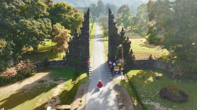Traveler Woman Running at the Gates Hindu temple Bali, Indonesia