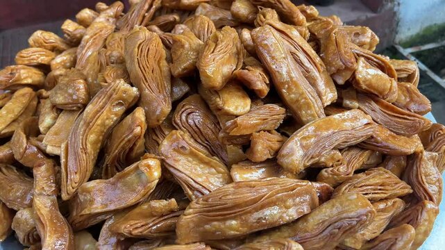Khaja an Odisha based sweet dipped in sweet syrup of gur. Closeup shot.