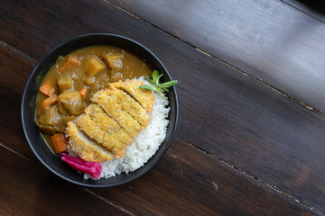 Japanese food is placed on wooden tables inside a restaurant