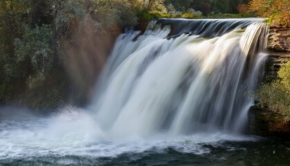 Fototapeta premium splashing white water cascading over a waterfall edge cellphone slo mo closeup