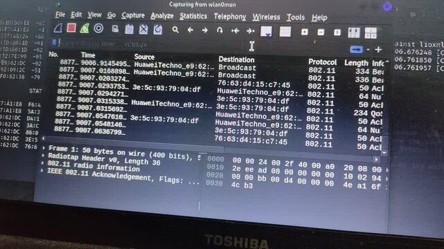 A close-up of a laptop screen running network packet analysis software on a Linux operating system. The interface displays data packets, sources, and protocols, commonly used for cybersecurity