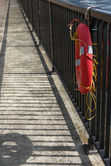 Lifebuoy Hanging on a Fence by the Waterfront