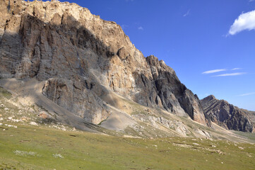 A perfect view of the harsh rocks and green plains from the peak of Shahdag in the Caucasus Mountains