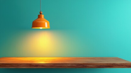 Obraz premium Modern pendant light over a wooden tabletop against a teal wall.