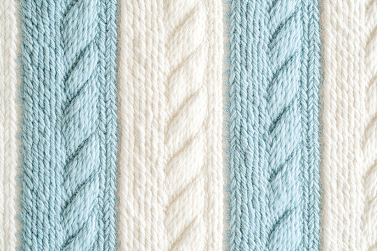 A textured background of a knitted garment with alternating light blue and white vertical cable stitch stripes. - Powered by Adobe