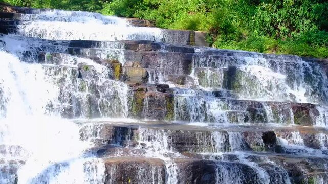 Scenic view of Nanu Oya waterfall with cascading water in Nuwara Eliya district, Sri Lanka