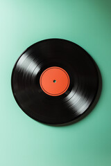 Obraz premium Classic black vinyl record isolated on a green backdrop
