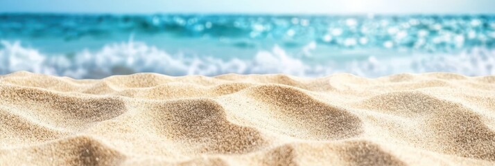 Obraz premium Soft white sand stretches across the beach, catching the sunlight while gentle waves lap at the shore. This vibrant seaside location is perfect for relaxation and recreation