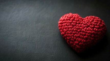 Obraz premium Red heart symbol on dark backdrop, conveying love and simplicity in a minimalist design.