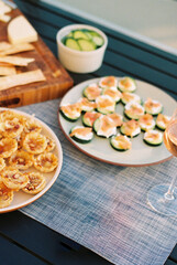 Elegant appetizers including cucumber salmon bites and cheese ta