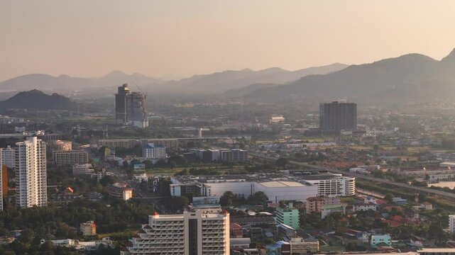 Hua Hin city area with modern condominium buildings and mountains in distance at sunset