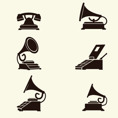 Fototapeta premium Vintage Communication and Entertainment Devices: A collection of old-fashioned gadgets, including gramophones, telephones, and music players, representing history.