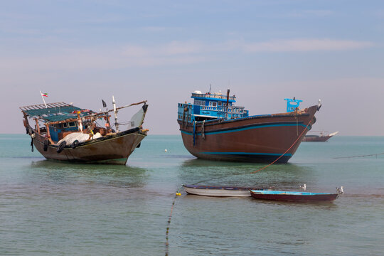 Fishing vessels rest in the calm waters of Bushehr, embraced by the endless sky and serene sea.