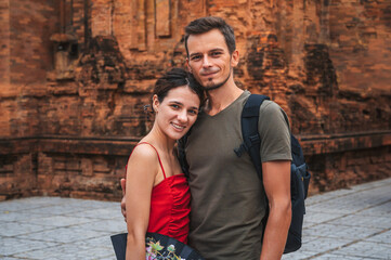 happy adult couple of tourists in love at ancient famous landmark of the Cham Towers of Po Nagar in Nha Trang in Vietnam in Asia