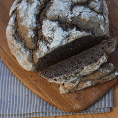Homemade  buckwheat bread  with some slices on a wooden cutitng board on a table