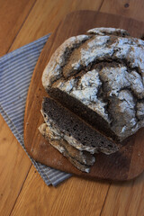 Homemade  buckwheat bread  with some slices on a wooden cutitng board on a table