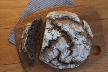 Homemade  buckwheat bread  with some slices on a wooden cutitng board on a table