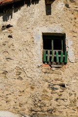 vertical view of the old window at a deteriorated facade